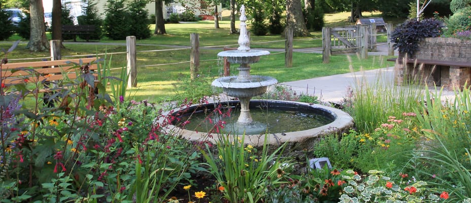 Beautiful outdoor garden with fountain and flowers