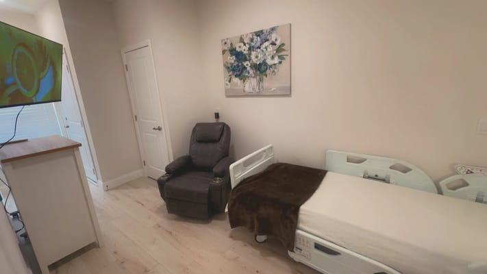 Cozy resident room with a hospital bed and recliner