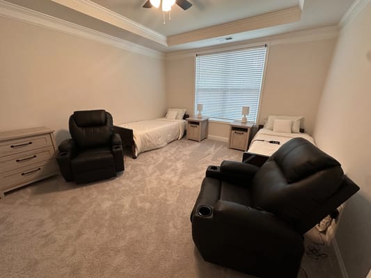 A well-furnished resident room with two beds