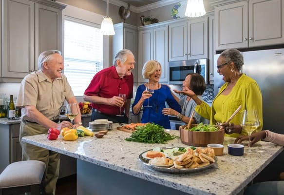 Residents enjoying a cooking activity in the kitchen