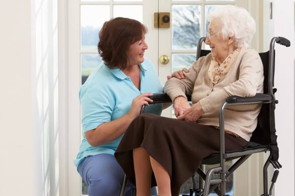 Staff member interacting with a resident in a lounge area