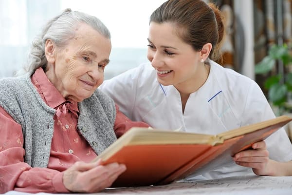 A caregiver reading with a senior resident