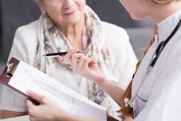 A nurse consulting with an elderly resident