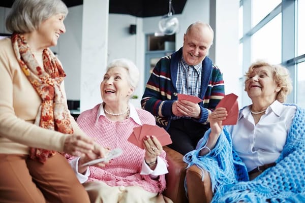 Residents enjoying a card game in a common area