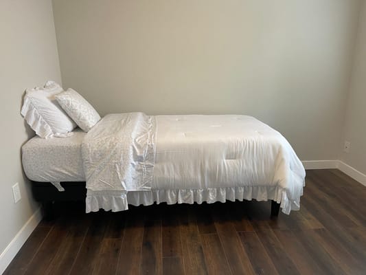 Simple bedroom with a single bed and plain decor