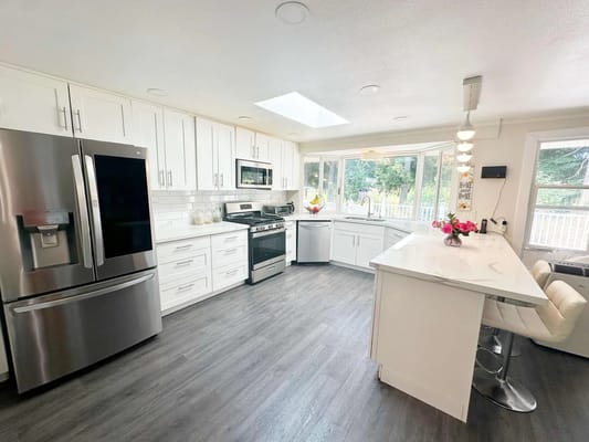 Modern kitchen with white cabinets and stainless steel appliances