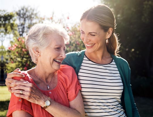 A staff member and resident enjoying time outdoors