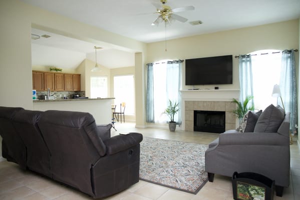 Bright common area with seating and a TV
