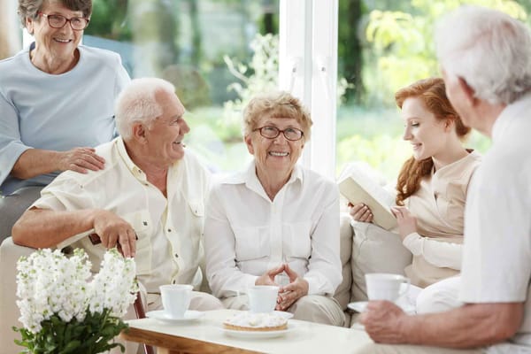 Residents engaging and smiling in a common area