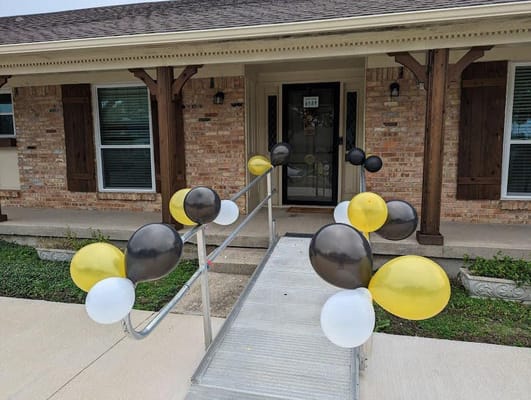 Exterior view of the building entrance decorated with balloons