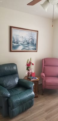 Cozy sitting area with recliners and flowers