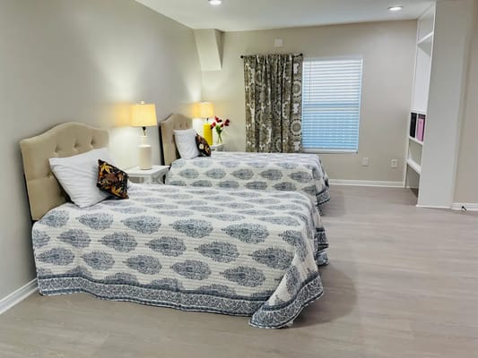 Bright interior of a shared resident room with two beds