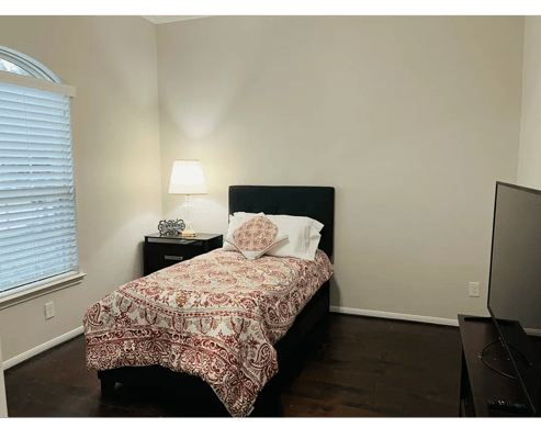 Cozy private room with a bed and lamp