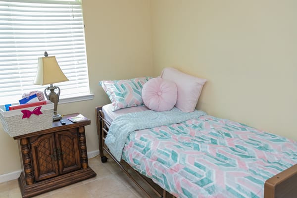 Cozy private bedroom with a bed and lamp