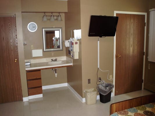 Interior view of a resident's room with a bed and television