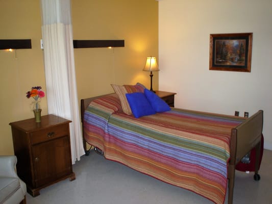 A private resident room with a colorful bedspread