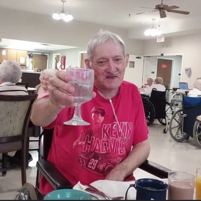 Resident raising a glass in the common area
