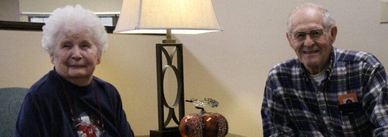 Two residents sitting together in a common area