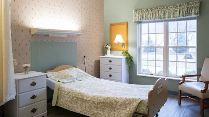 Cozy private resident room with a bed and window