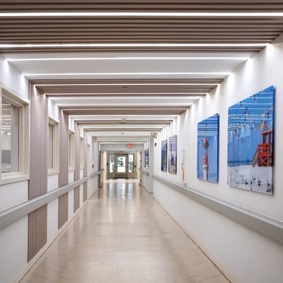 Brightly lit interior hallway with artwork on the walls