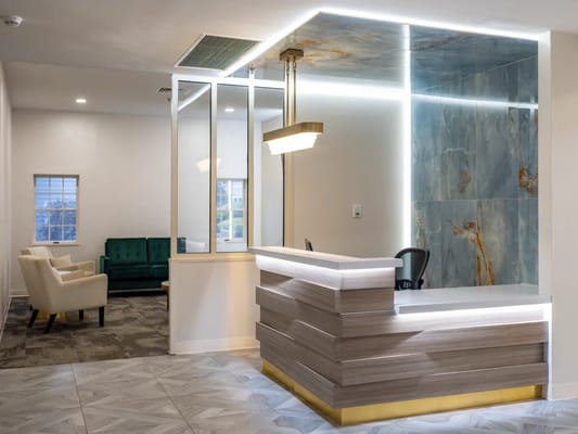 Modern reception area with seating and desk