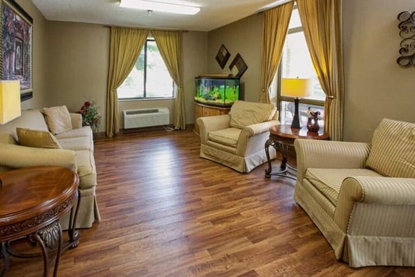 Bright common area with comfortable seating and aquarium