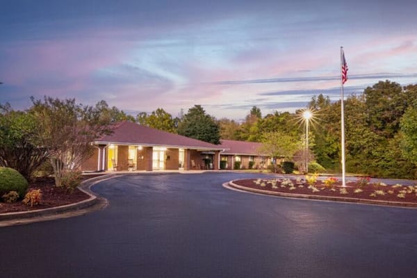 Exterior view of a senior living facility at sunset