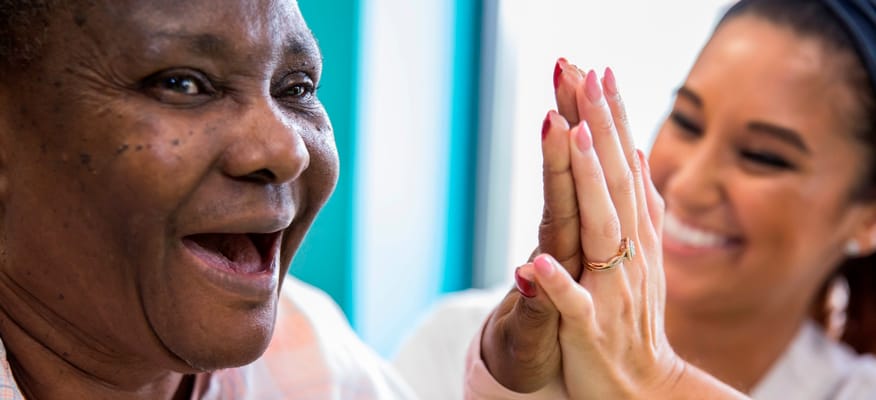 A joyful interaction between a resident and staff member