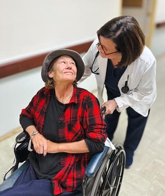 A nurse assisting a resident in a wheelchair