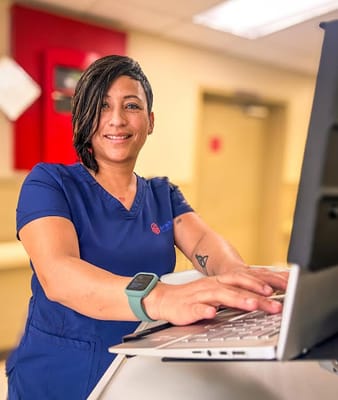 Staff member assisting with technology at a reception area
