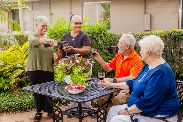 Residents enjoying drinks together in a garden setting