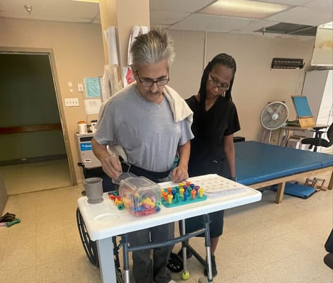 Resident participating in an activity with staff member.