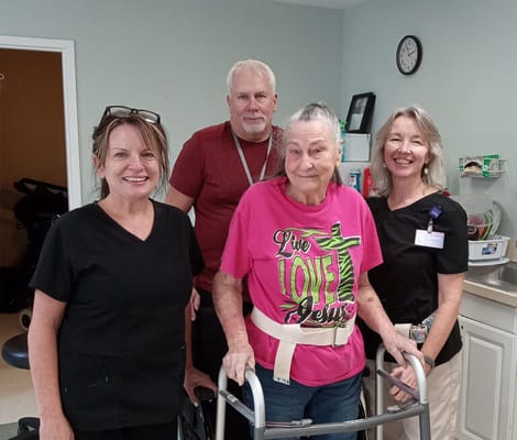 Staff assisting a resident inside the facility