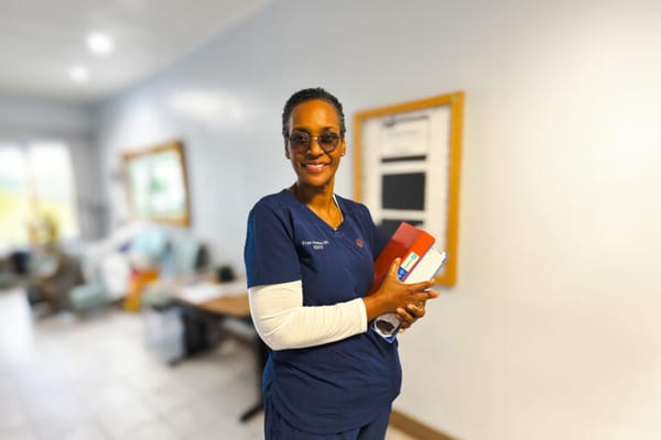 Staff member smiling in a facility interior