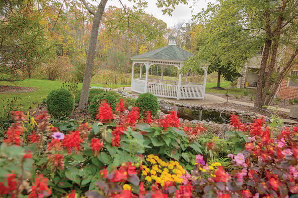 Beautiful gazebo surrounded by colorful flowers in a garden