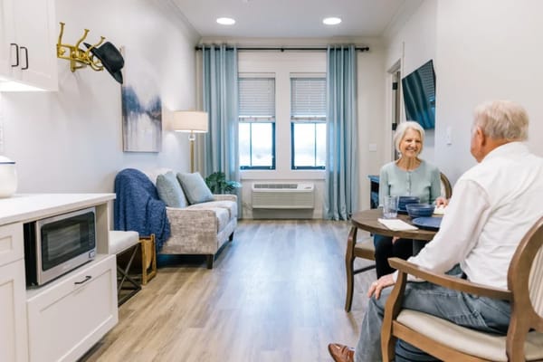 Resident and staff interacting in a cozy sitting area