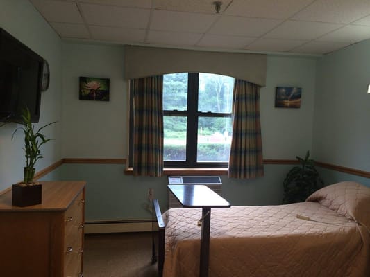 A cozy resident room with natural light