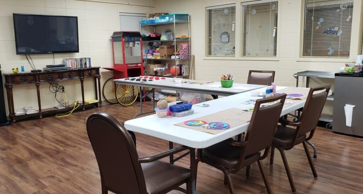 Activity room with tables and art supplies