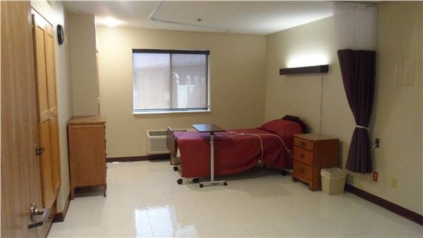 Empty resident room with a bed and furniture