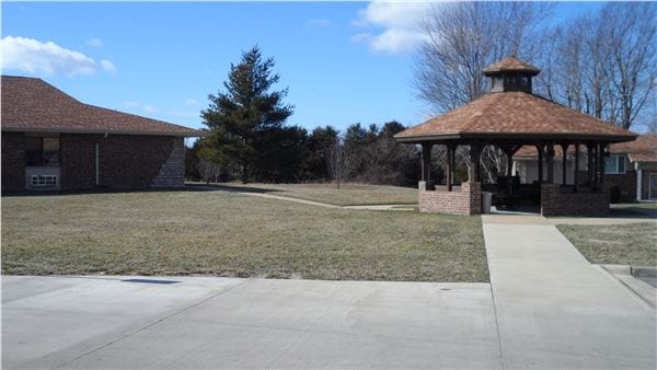 Outdoor space with a gazebo and grassy area
