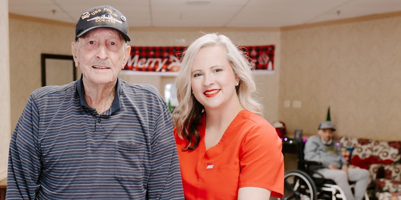 A staff member with a resident in a common area