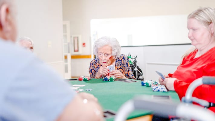 Residents playing poker in an activity room