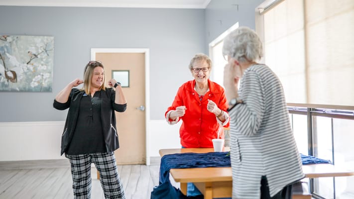 Residents engaging in a fun activity in a bright room
