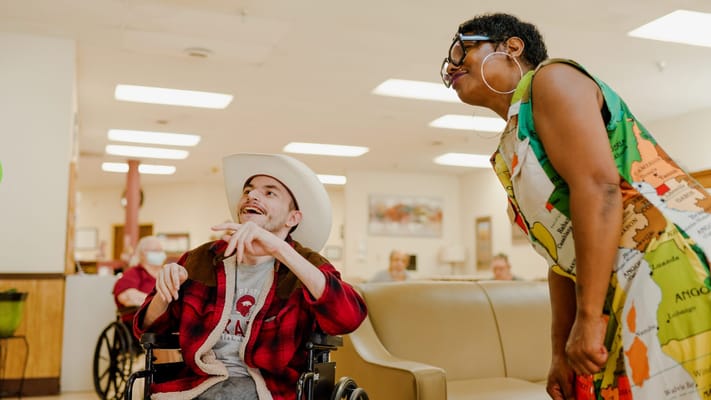 Engaged resident and staff member in a common area