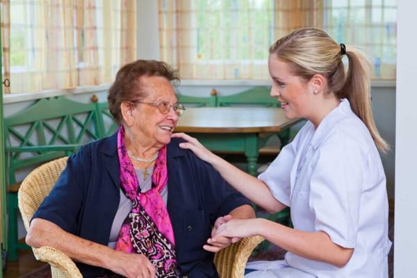 Caregiver interacting with a resident in a cozy setting