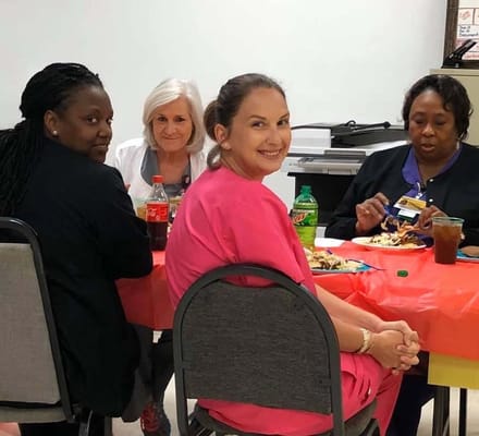 Residents and staff enjoying a meal together