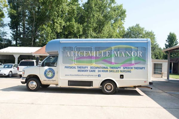 A van with Aliceville Manor branding parked outside