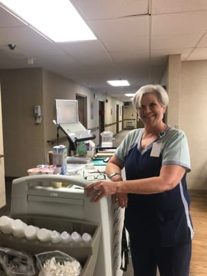 Staff member assisting in an interior facility setting