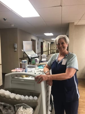 Staff member assisting in an interior facility setting