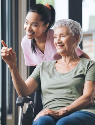 Senior resident enjoying a conversation with staff member